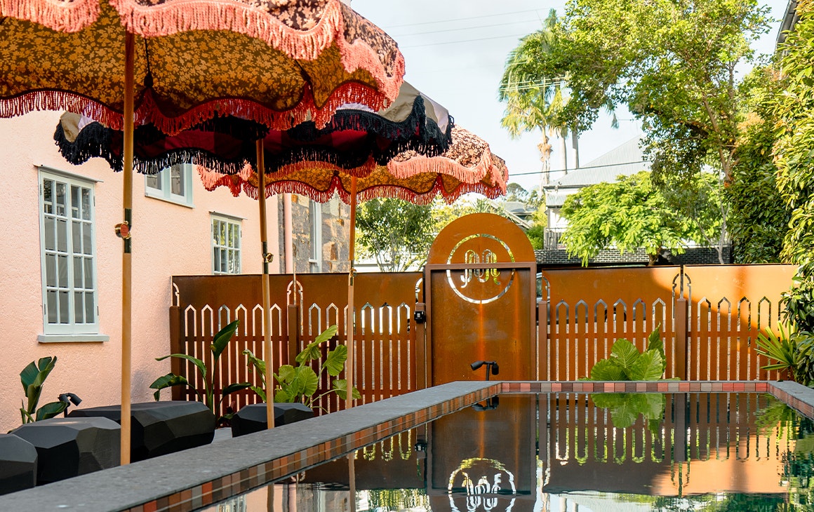 pool with fabric umbrellas